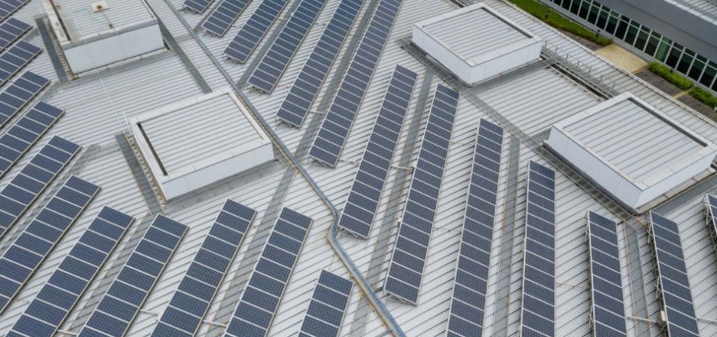 Solar panels installed on a commercial building, emphasizing renewable energy and financing options for roof replacement.