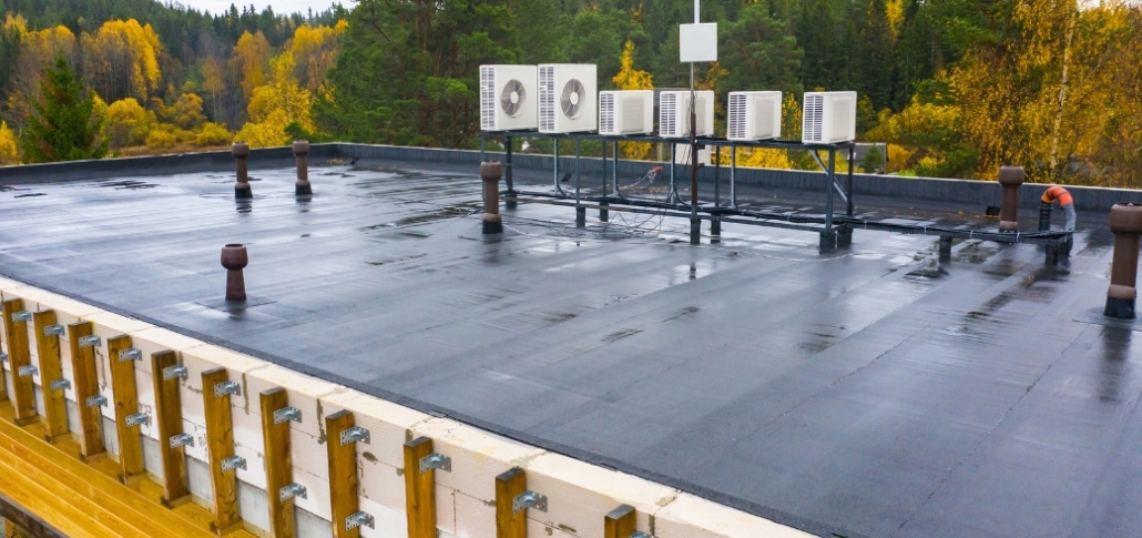 A wet commercial flat roof, illustrating climate considerations for building maintenance.