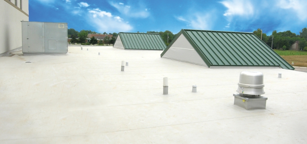 A flat roof design showcasing green and white metal roofing, highlighting essential components of commercial roofing types.