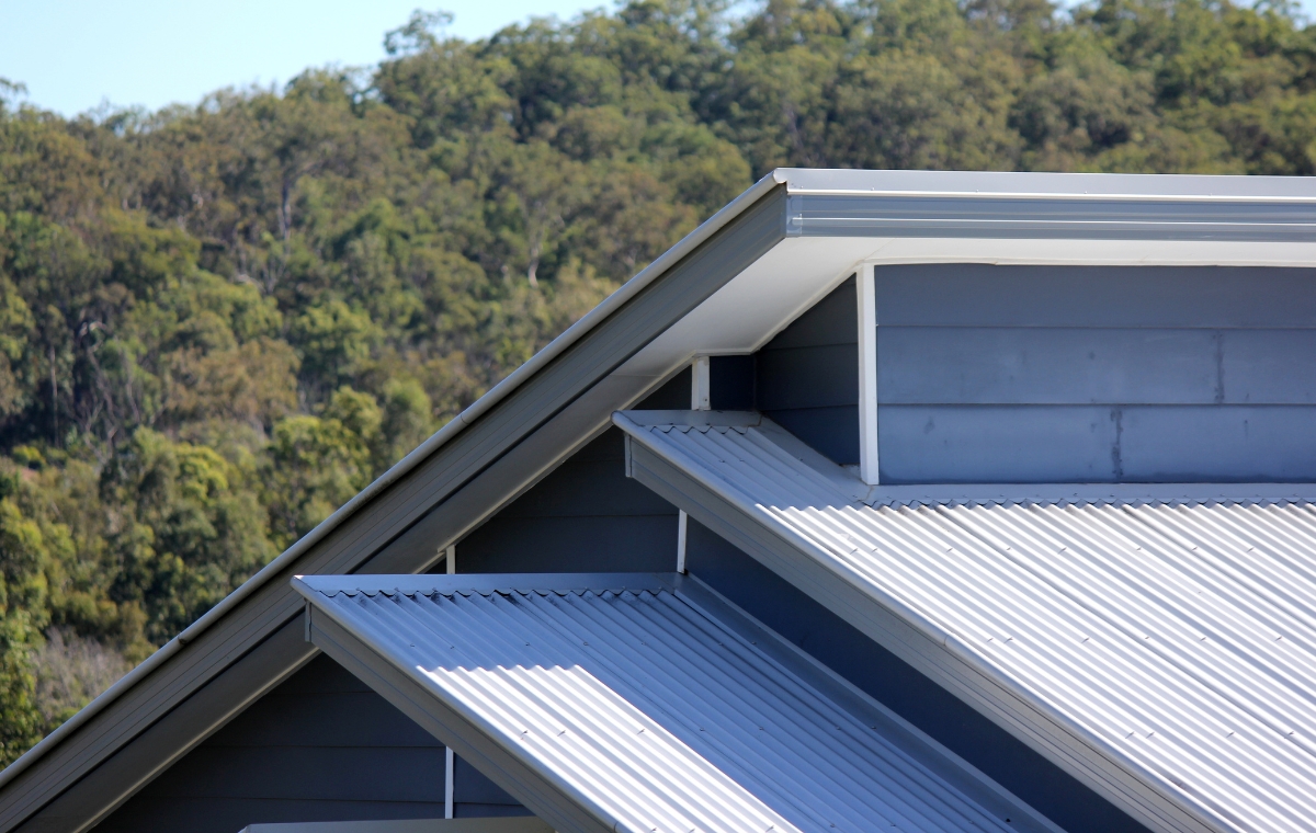 A commercial roof displaying a sleek metal roofing system, highlighting the craftsmanship of Connecticut's metal roofers.