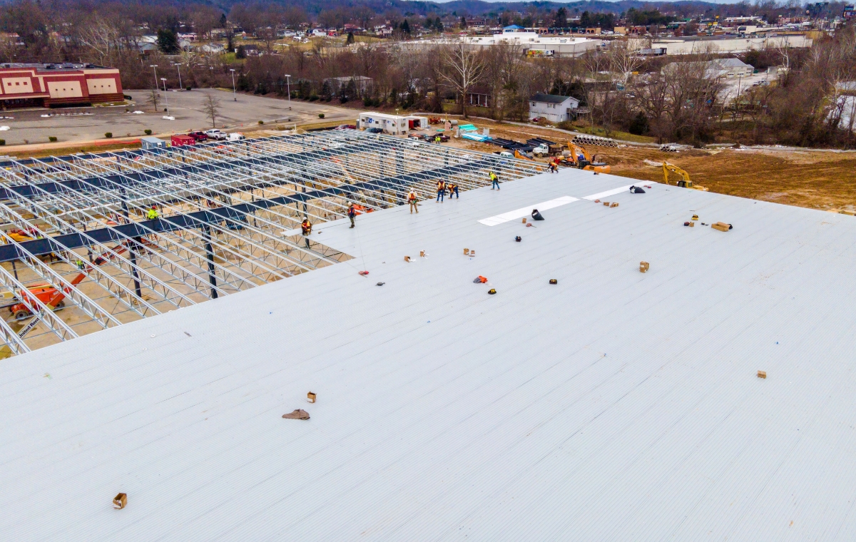 Aerial view of a building under construction, showcasing the new roof installation for a business project.
