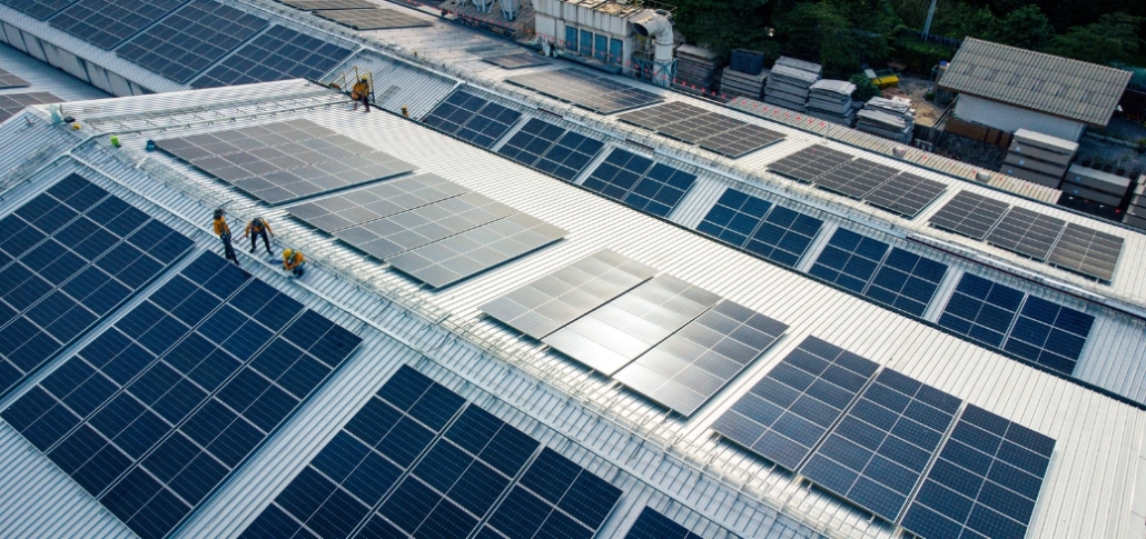 Aerial view of solar panels installed on a roof, illustrating suitability for commercial solar energy systems.