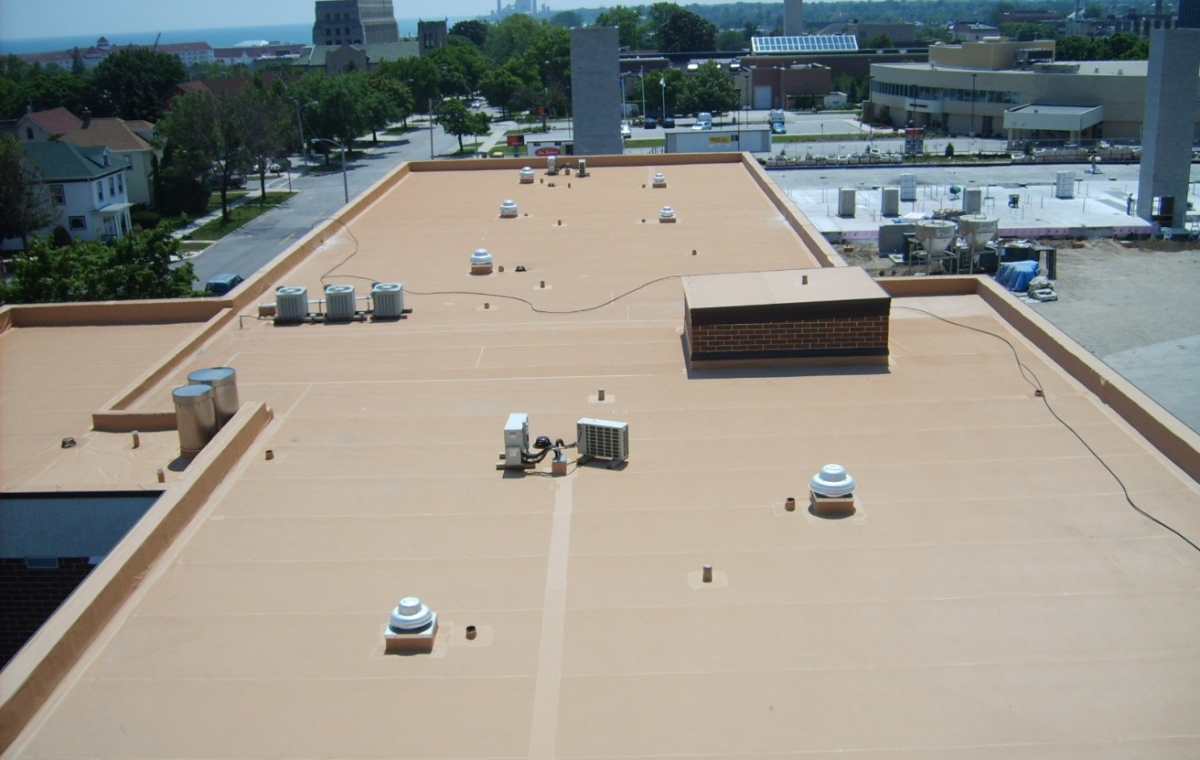 A commercial roof in Hartford, CT, featuring a large flat surface with various electrical equipment installed.