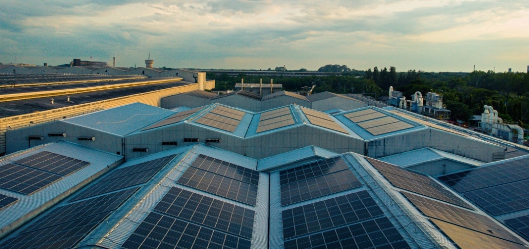 Solar panels on the roof of a manufacturing building, emphasizing the integration of green technology in industrial roofing.