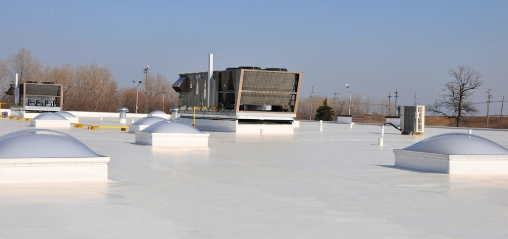 A large white TPO roof equipped with multiple air conditioning units, typical for manufacturing environments.